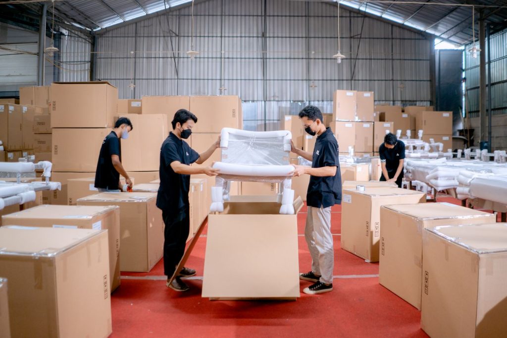 Workers packaging products into branded shipping boxes