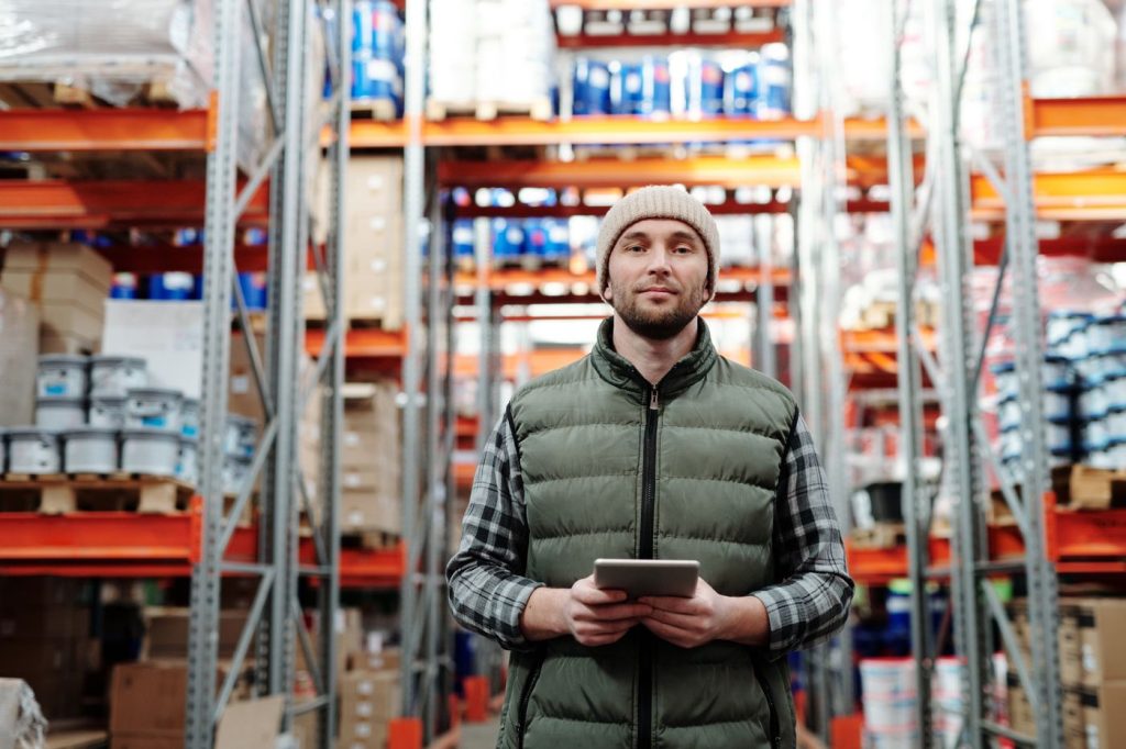 Warehouse manager reviewing sample inventory on tablet